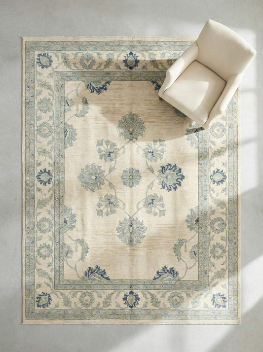 Hand knotted wool Oushak rug with muted blue floral design and vintage botanical motifs