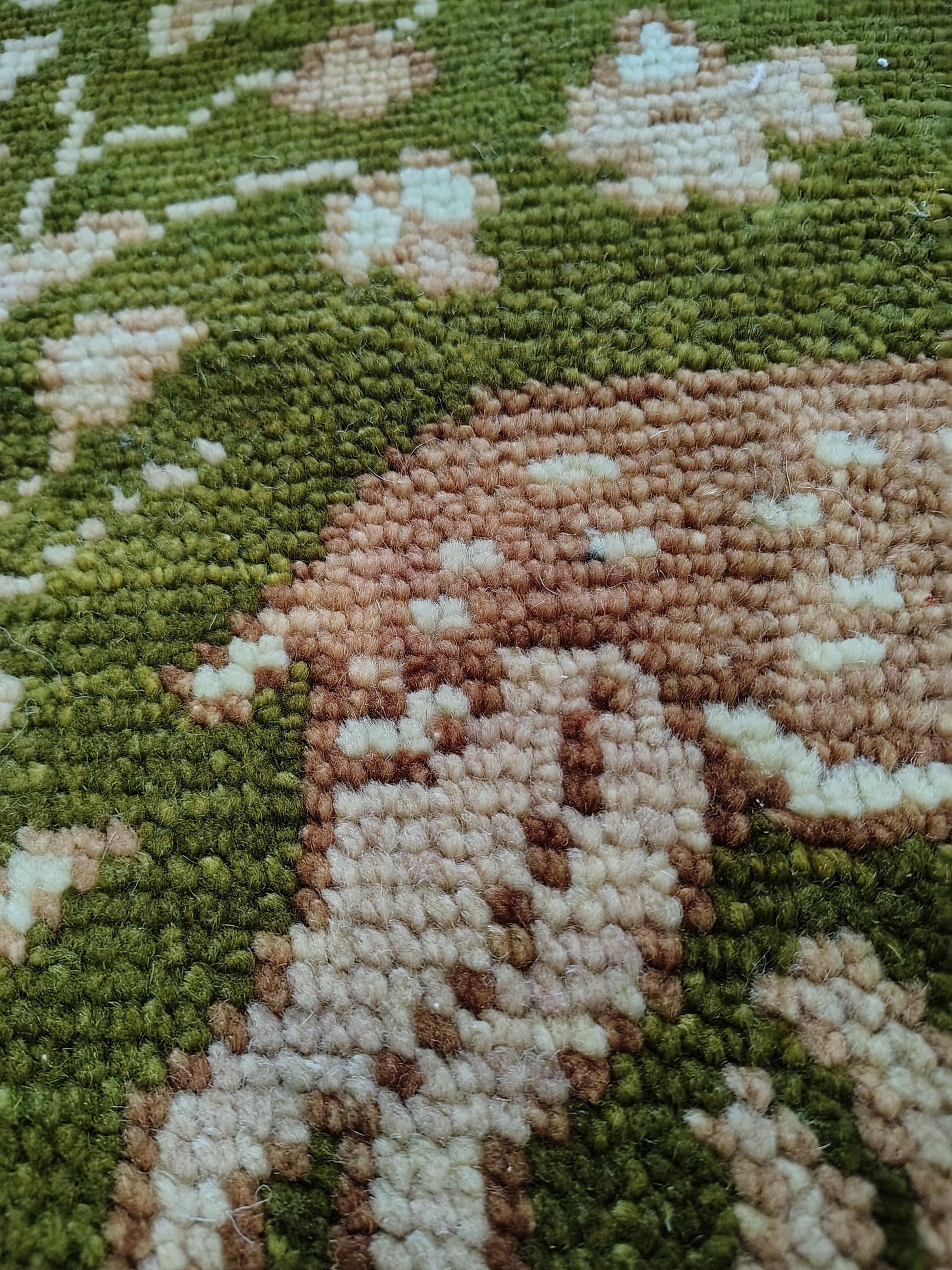 Hand knotted wool rug with Persian animal motifs, olive green field, and navy floral border