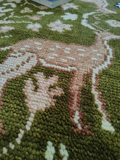 Hand knotted wool rug with green Persian animal motif and navy floral border