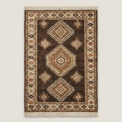 Traditional hand knotted wool rug with geometric diamond motifs and earthy tones