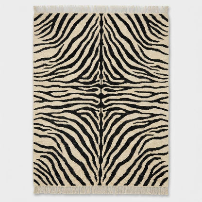 Modern abstract striped wool rug with bold black pattern on ivory background