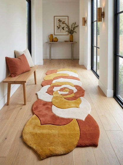 Hand tufted irregular-shaped abstract floral runner rug in mustard yellow, burnt orange, and ivory cream wool for modern hallway decor