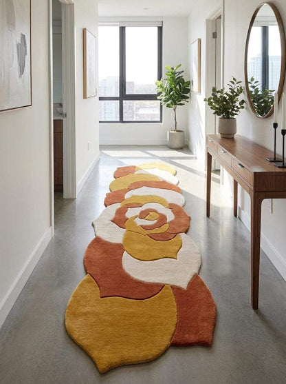 Hand tufted abstract floral runner rug in mustard yellow, burnt orange, and ivory cream with irregular shape for modern hallway decor