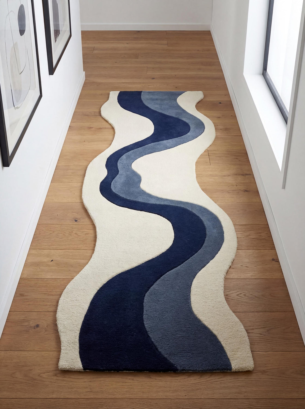 Hand tufted abstract runner rug with navy blue wave design on ivory background, irregular shape hallway carpet