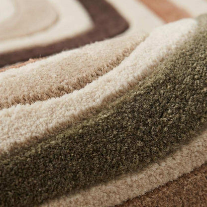 Hand tufted abstract wool rug with retro wavy pattern in neutral earthy tones