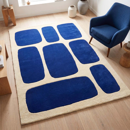 Hand tufted blue geometric wool rug displayed in a modern living room with contemporary furniture and light wood flooring __etsy:8083836900