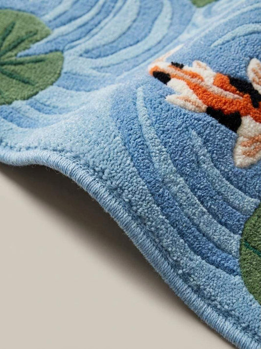Close up of hand tufted wool rug pile showing carved water ripple texture and raised koi fish details __etsy:7840770591