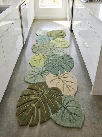 Contemporary botanical hallway rug featuring dimensional carving and layered tropical leaf artwork in calming green shades __etsy:8092843808