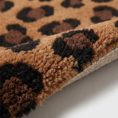 Close up of thick hand tufted wool pile showing dense cut fibers and plush leopard pattern detailing in brown and black tones