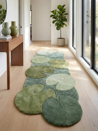 Handmade runner rug combining hallway runner styling with layered round lily pad forms and organic shapes arranged over a long rectangular base. __etsy:8092988108