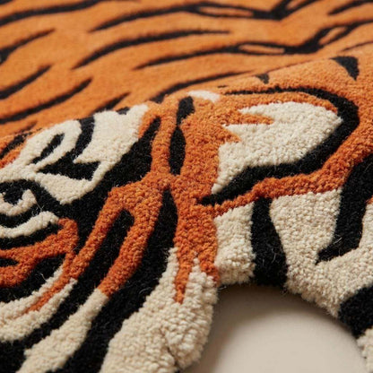 Close up of hand tufted wool rug texture showing dense cut pile fibers forming tiger stripe pattern in orange black and ivory __etsy:7789952528