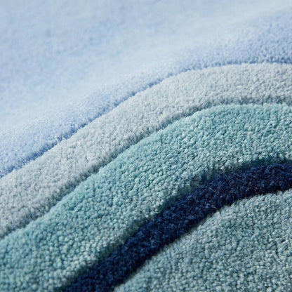 Close-up texture of handmade wool hand tufted rug showing dense cut pile and layered blue border detailing __etsy:8084464013