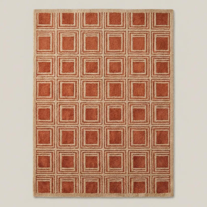 Modern rust terracotta wool area rug with geometric square grid design styled beside accent chair and wooden console