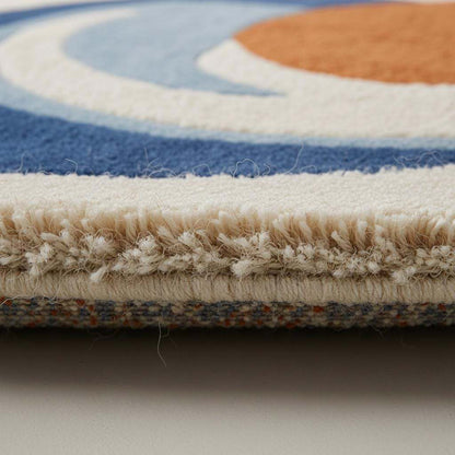Hand-tufted wool rug with modern abstract blue and orange round design