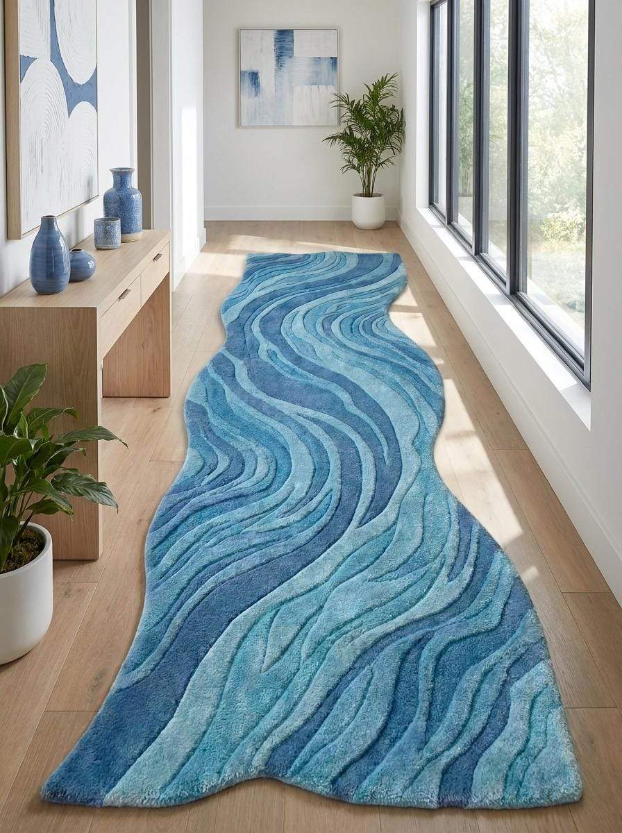 Contemporary blue carpet runner with sculptural edges and layered wave motifs creating movement and visual depth. __etsy:8140856581