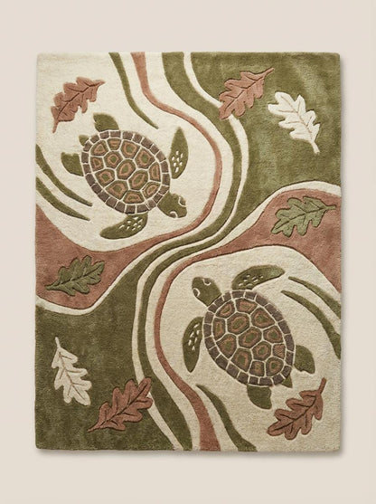Hand tufted wool area rug with raised turtle and nature design in coastal living room setting
