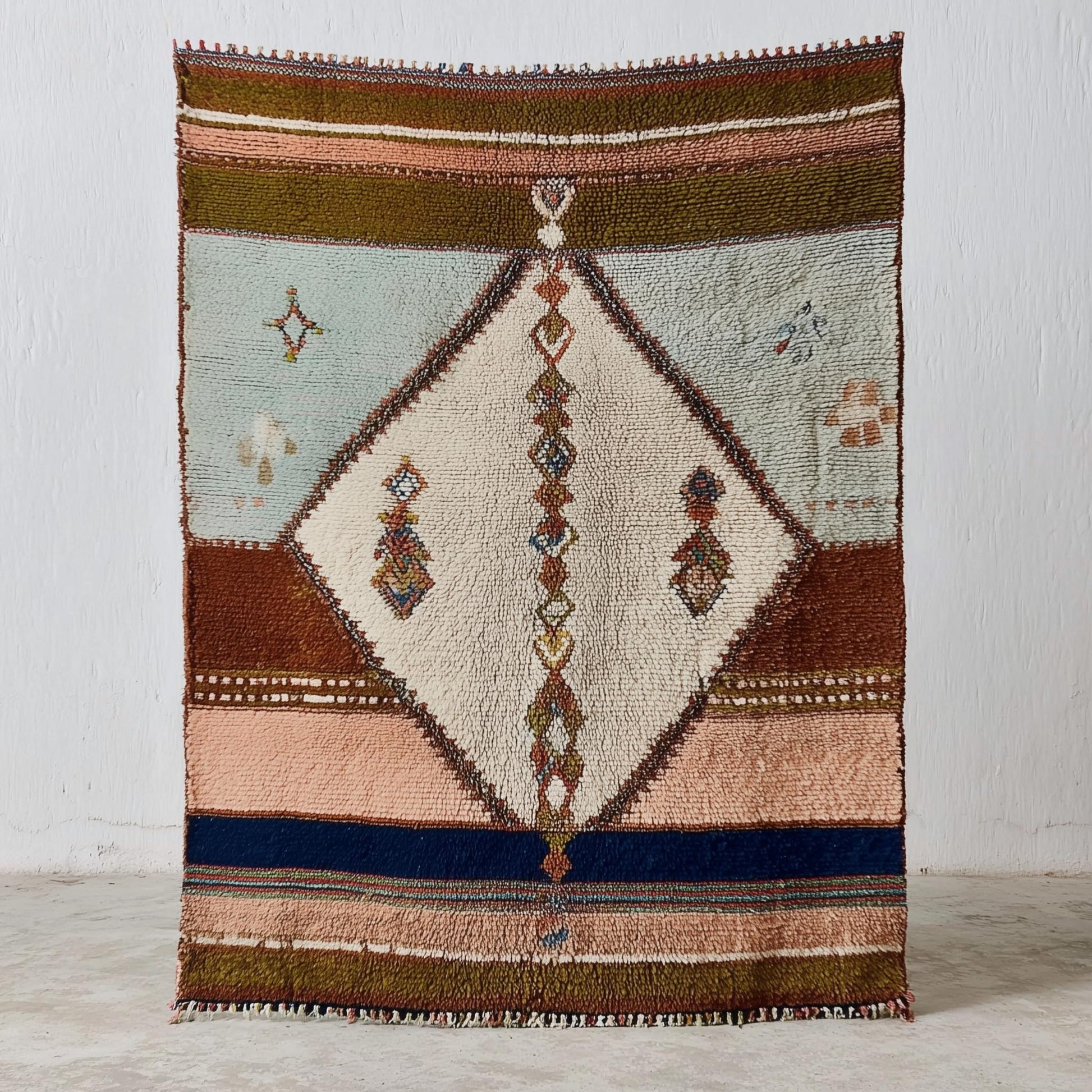 Hand-woven Moroccan wool rug with blush pink and sage Berber design