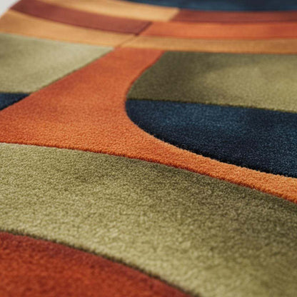 Handmade retro rug with curved geometric pattern in burnt orange, olive green, navy, and amber gold wool tufted carpet