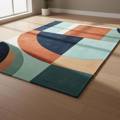 Handmade wool rug with modern retro geometric pattern in navy, terracotta, mint, and cream colors
