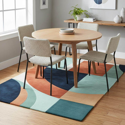 Handmade wool rug with modern retro geometric pattern in navy, terracotta, mint, and cream colors
