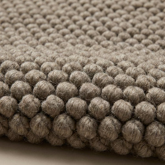 Neutral handmade chunky knit wool rug with thick texture for cozy interiors