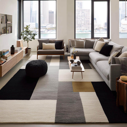 Overhead view of a modern high-pile rug with a bold, graphic pattern.