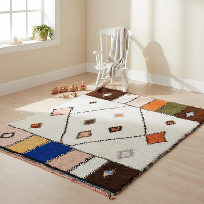 Boho handmade wool area rug, ethnic floor carpet style in cream with bold accent colours including cobalt blue and blush pink.