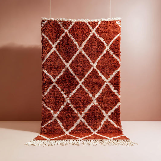 Handmade Moroccan shag rug in terracotta wool with diamond pattern and off-white fringe for boho home decor.