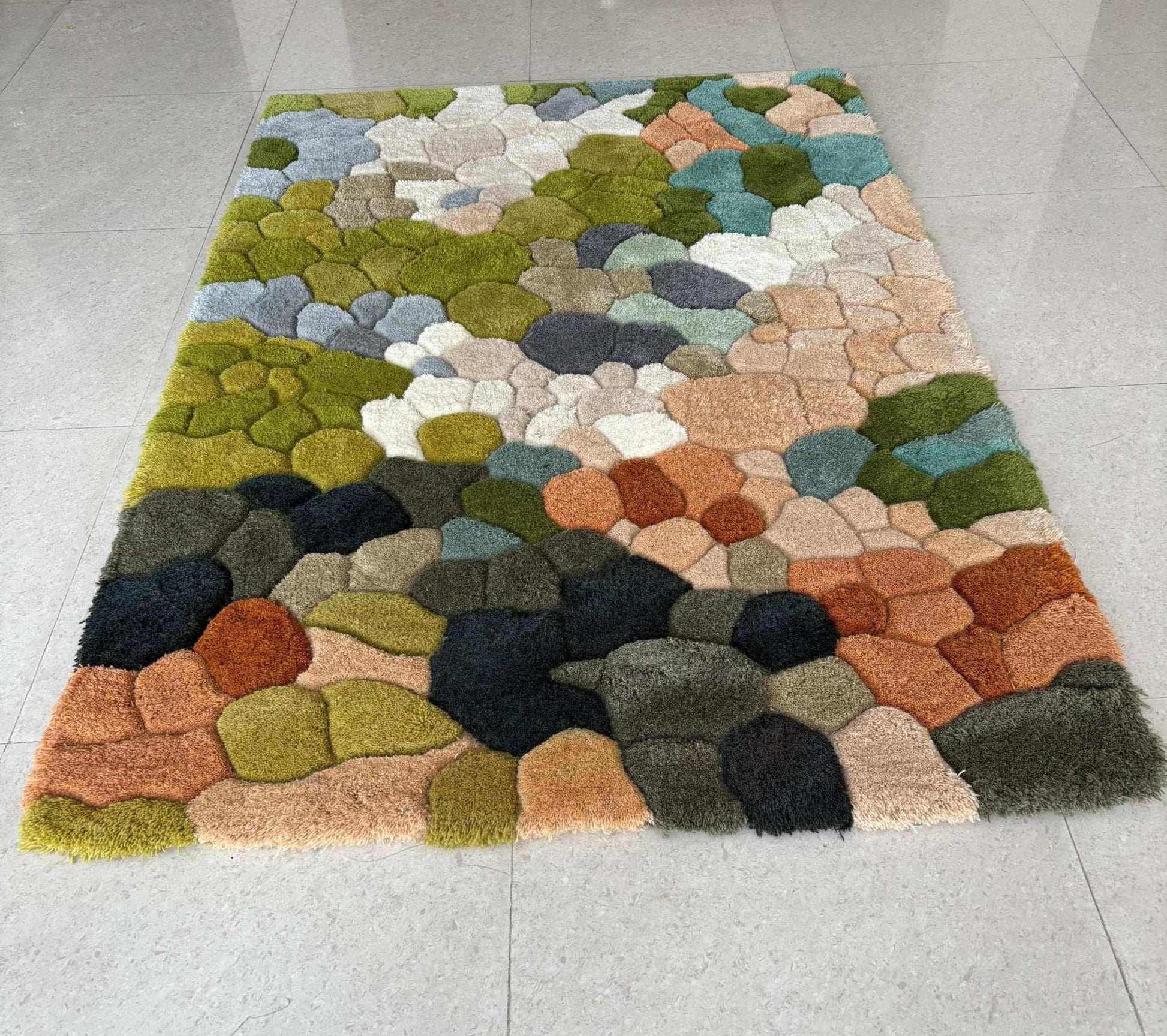 Handmade wool tufted moss rug with nature-inspired forest floor design in muted colors