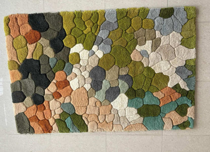 Handmade wool tufted moss rug with nature-inspired forest floor design, soft and cozy texture, rectangular shape, perfect for living room and kids play room decor.