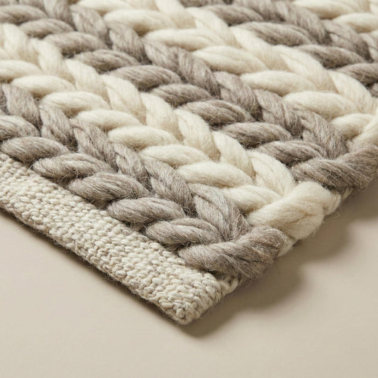 Handwoven chunky wool braided rug in neutral tones for farmhouse and minimalist decor