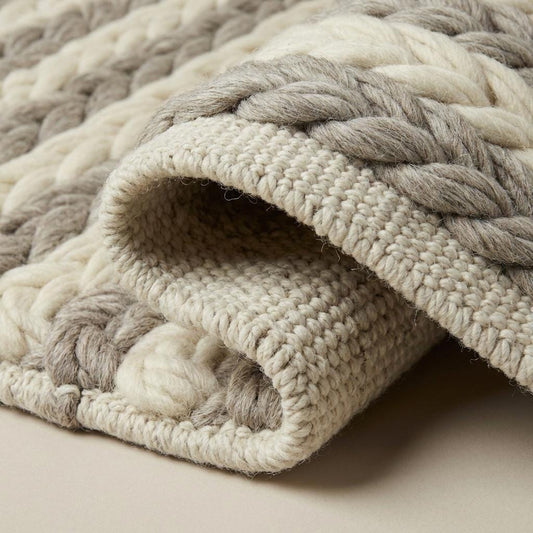 Handwoven chunky wool braided rug in neutral tones for cozy farmhouse and minimalist decor