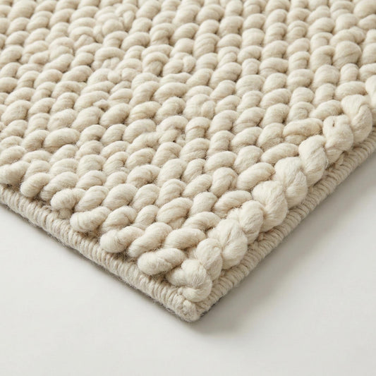 Handwoven chunky wool rug with thick braided loops in neutral Scandinavian décor style