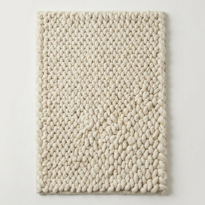Handwoven chunky wool rug with thick braided texture in neutral color for Scandinavian décor