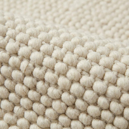 Handwoven chunky cream wool rug with thick knit texture for cozy Scandinavian decor