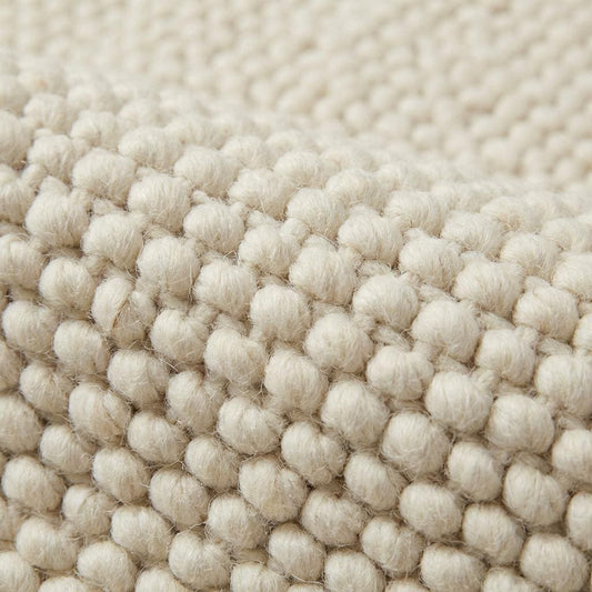 Handwoven chunky cream wool rug with thick knit texture for cozy Scandinavian decor