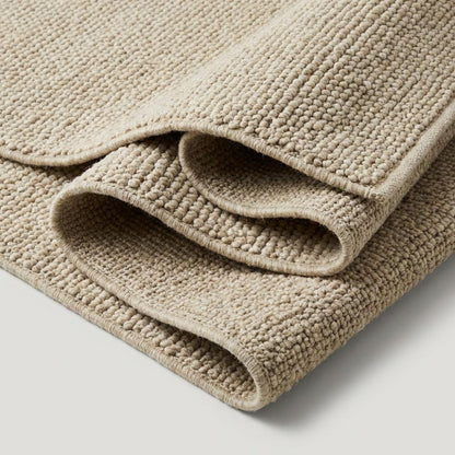 Handwoven chunky wool rug in neutral beige with thick loop texture for cozy farmhouse style