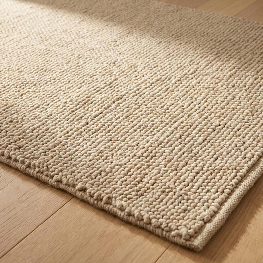 Handwoven chunky wool rug with thick looped weave in neutral beige farmhouse style
