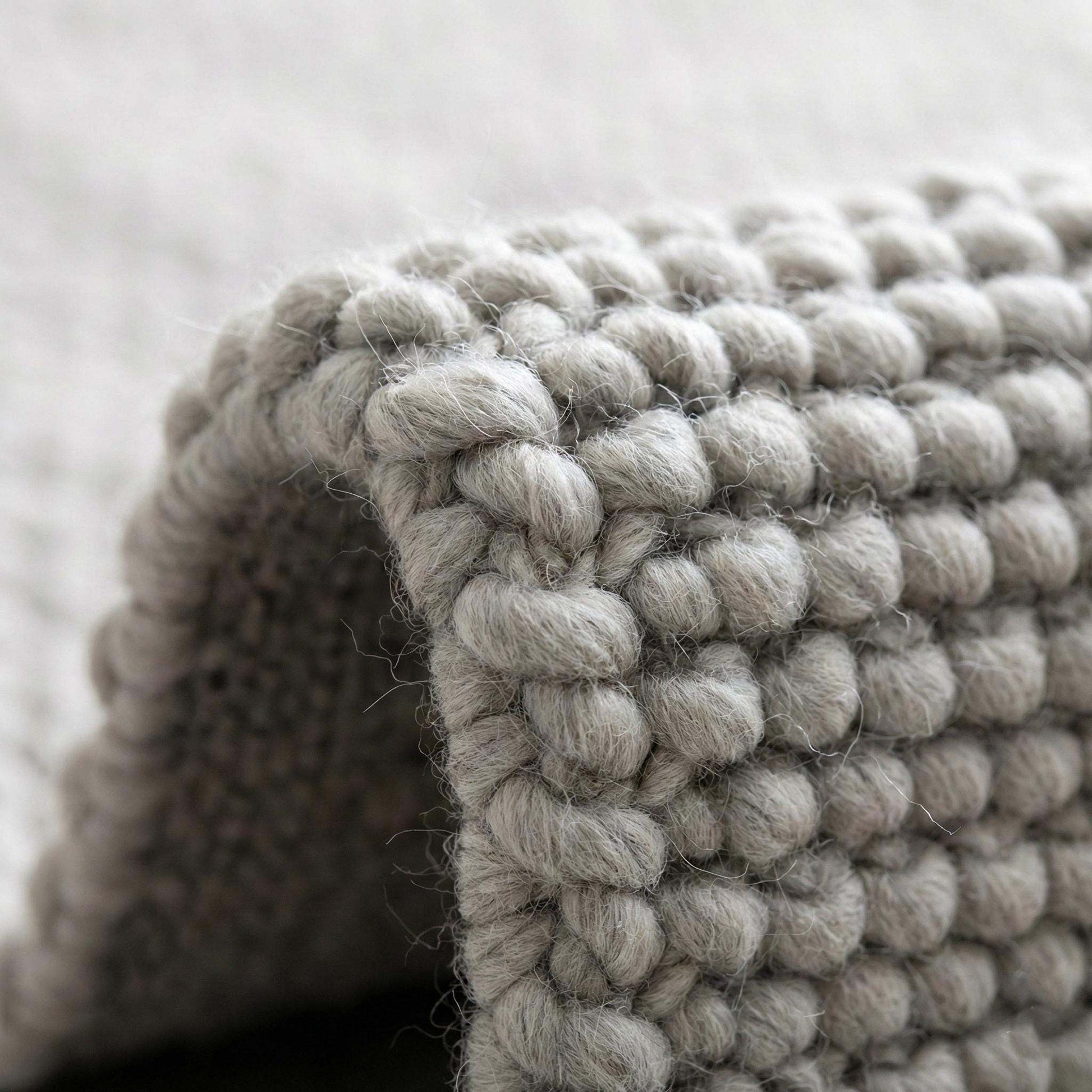 Handwoven chunky wool rug in neutral gray with thick weave for cozy Scandinavian farmhouse decor
