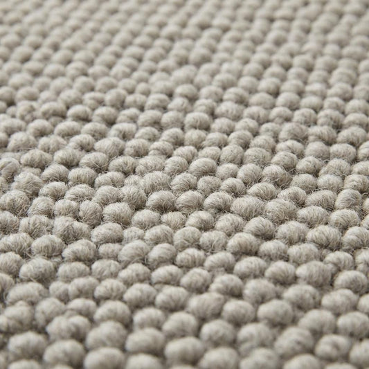 Handwoven chunky wool rug in neutral gray with thick texture for Scandinavian farmhouse decor