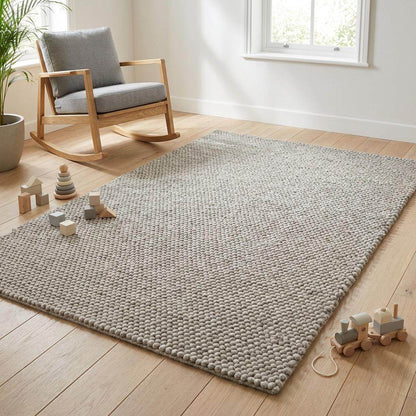 Handwoven chunky wool rug in neutral gray for Scandinavian farmhouse decor with thick natural wool weave