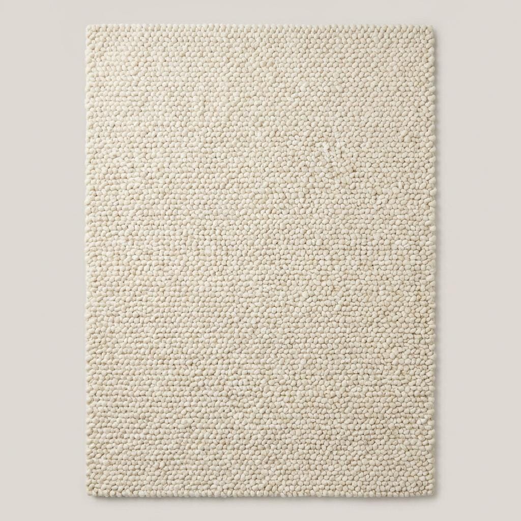 Handwoven chunky wool rug in neutral cream with thick, cozy texture for Scandinavian decor