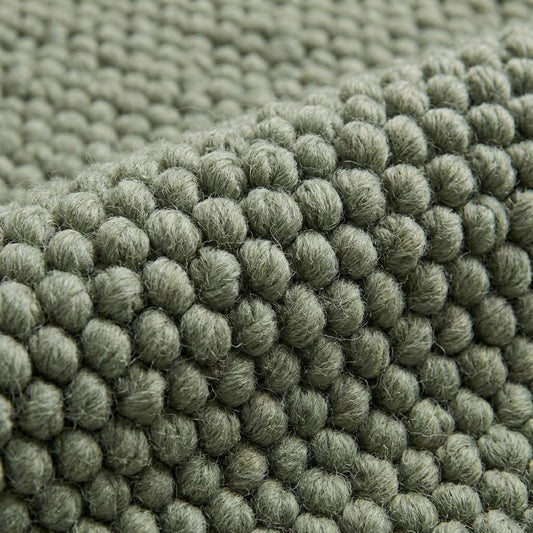 Handwoven chunky wool rug with thick texture in neutral tones for Scandinavian home decor