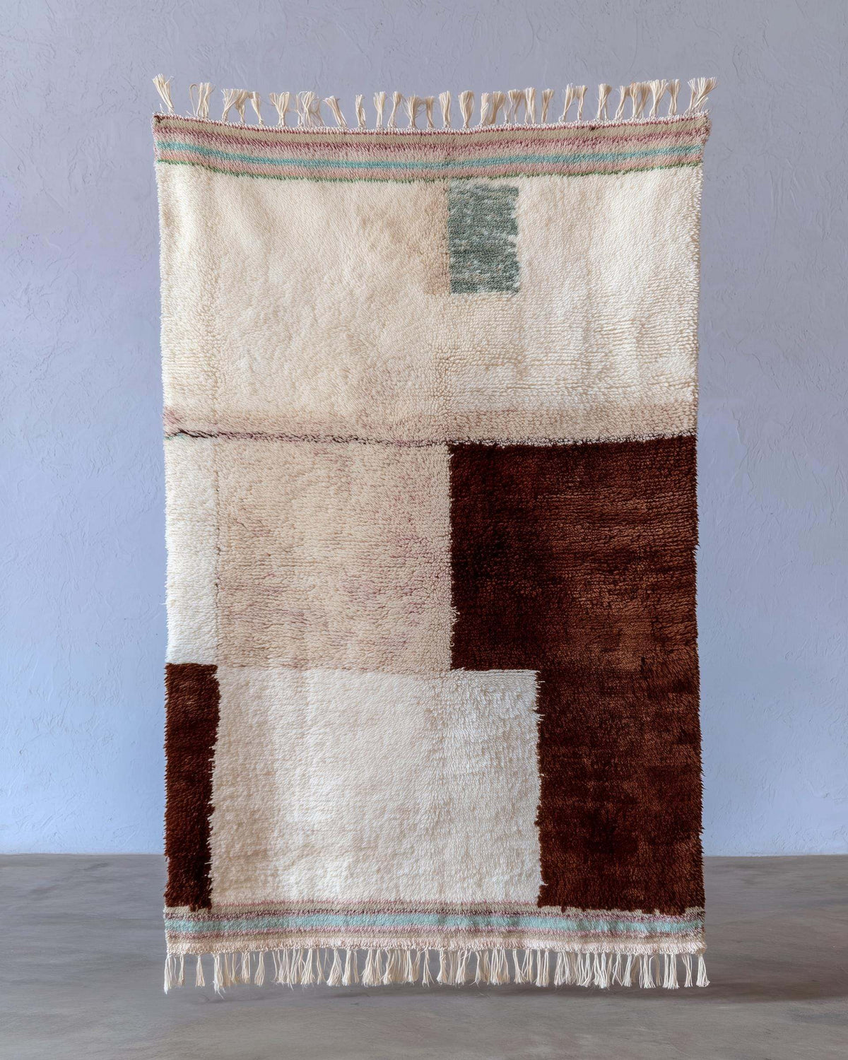 Handwoven Moroccan Berber wool rug with cream base, chocolate blocks, peach highlights, mint stripes, and high-pile shag texture