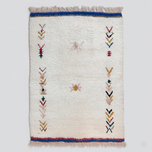 Handwoven Moroccan wool rug with cream Berber tribal motifs for boho home decor