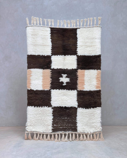 Handwoven Moroccan wool shag rug with cream and chocolate checkerboard pattern and soft peach accents