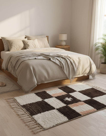 Handwoven Moroccan wool shag rug with cream and chocolate checkerboard pattern and soft peach accents