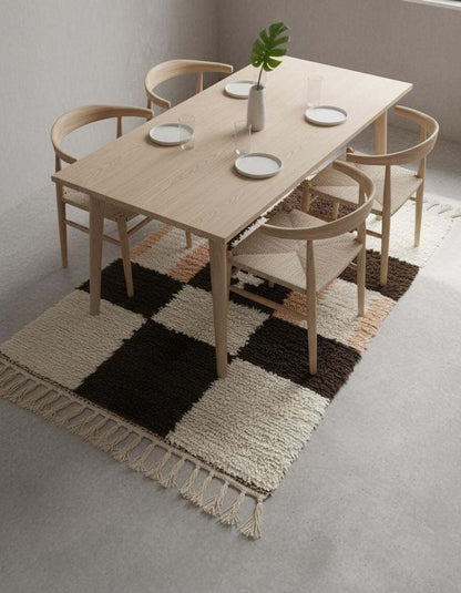 Handwoven Moroccan wool shag rug with cream and chocolate checkerboard pattern and soft peach accents