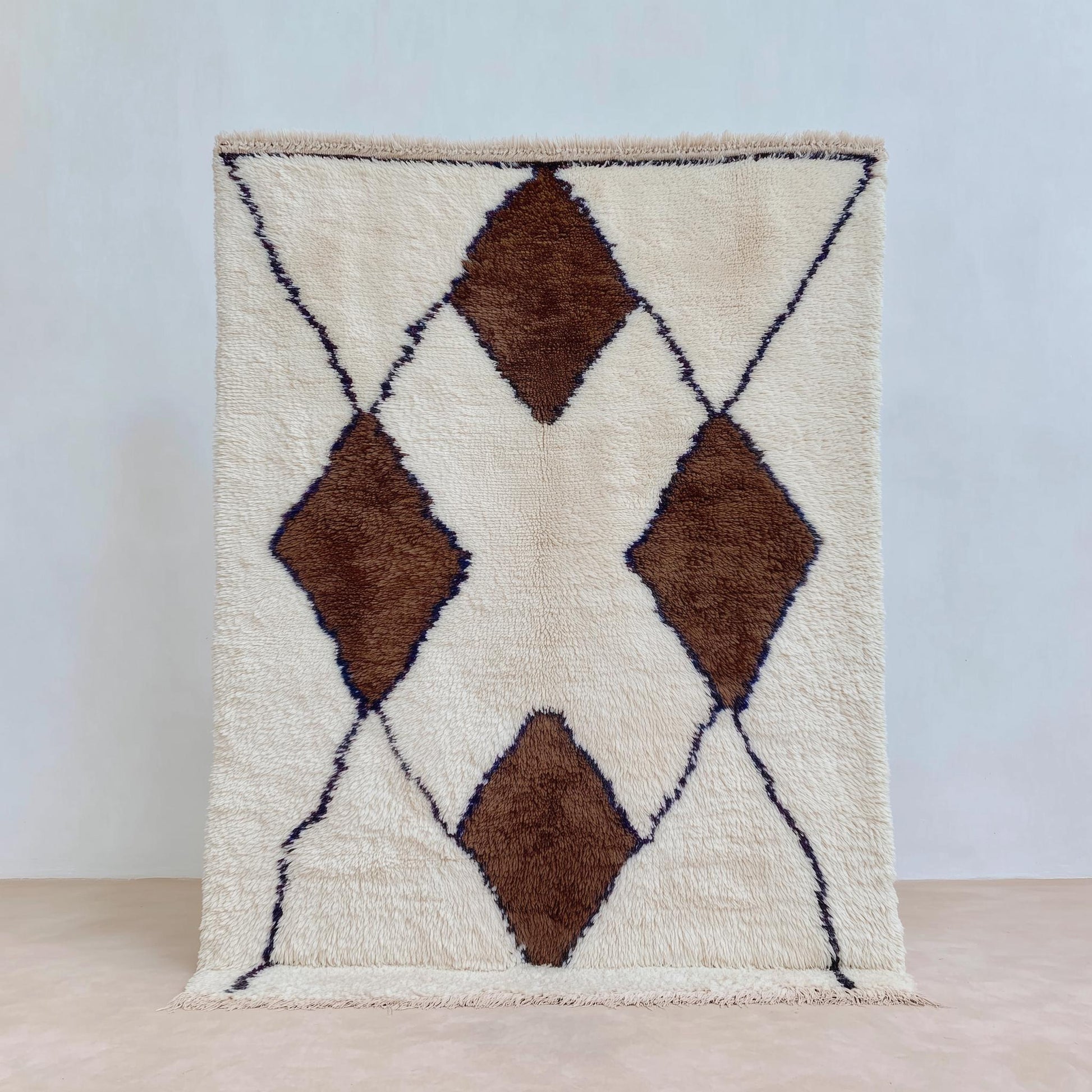 Handwoven Wool Beni Ourain Rug with ivory background and brown diamond motifs, plush Moroccan wool area rug