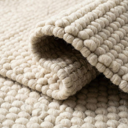 Handwoven wool rug with chunky loop pile in neutral ivory for modern minimalist decor